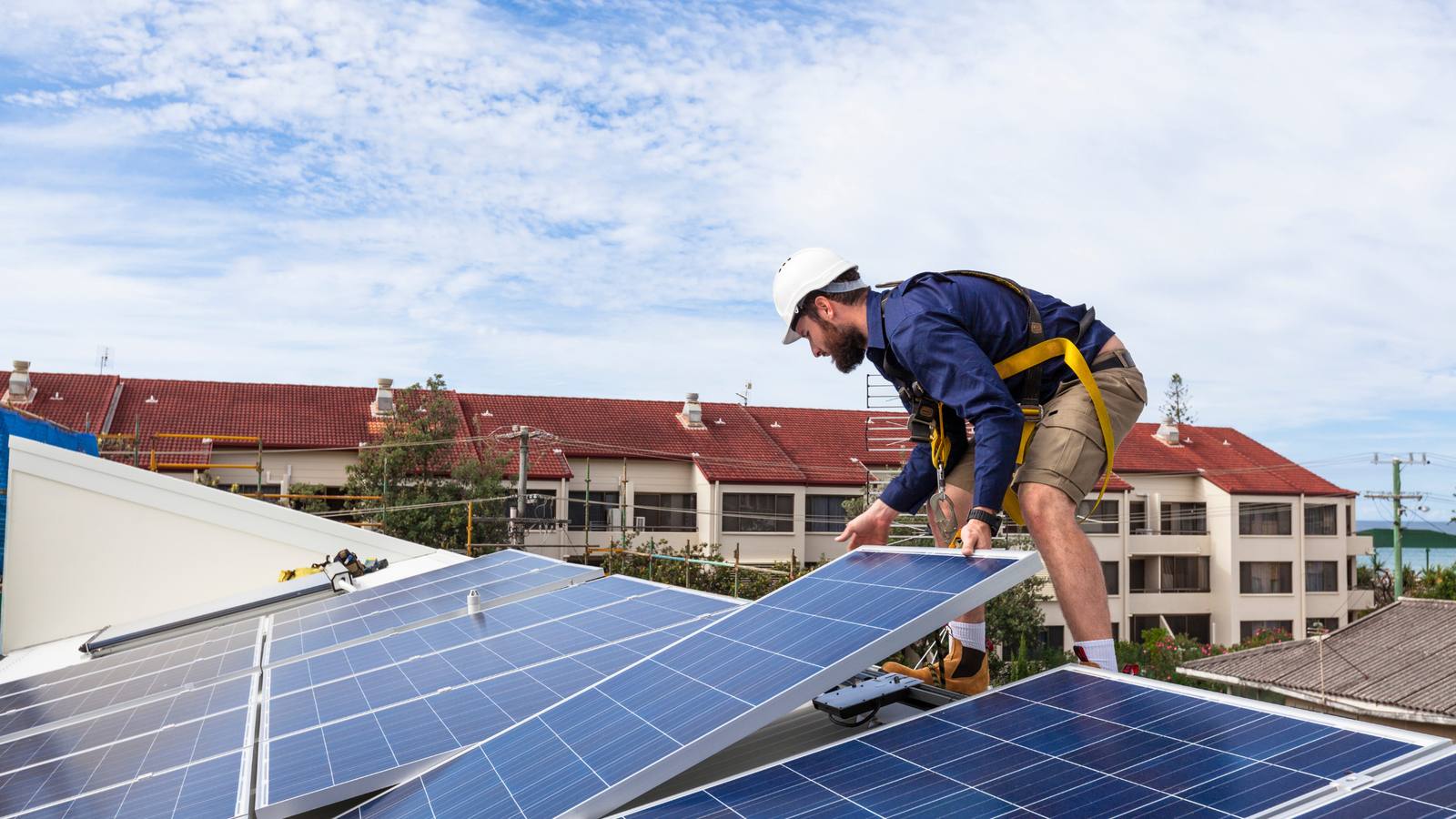 Solar installer fitting panels on a roof